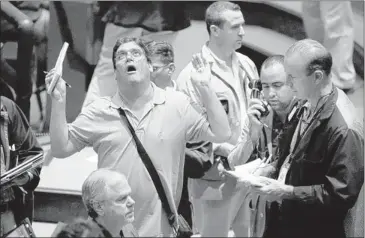  ?? RICHARD DREW / ASSOCIATED PRESS ?? Anxious traders work the options pit at the New York Mercantile Exchange, where oil rose above $101 a barrel on Wednesday.