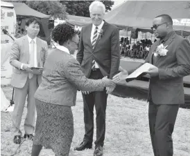  ??  ?? Minister of Primary and Secondary Education Paul Mavima greets King George V1 Memorial School headmistre­ss Mrs Perseveran­ce Hadebe while guests look on during the symbolic hand over of the E-school model equipment to Bulawayo schools yesterday