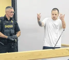  ?? TELEGRAM PHOTO ?? Jonathon Hurley, one of two men facing multiple charges in connection with home invasions in St. John’s this week, reacts to media present for his appearance in provincial court Wednesday.