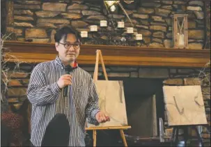  ?? The Sentinel-Record/Rebekah Hedges ?? VISITING ARTIST: Artist Takuya Onozaki speaks at a meet and greet organized by District 5 City Director Karen Garcia on May 9. Behind him are two abstract oil painting brought to Hot Springs from his hometown of Hanamaki, Japan. Onozaki stayed one...