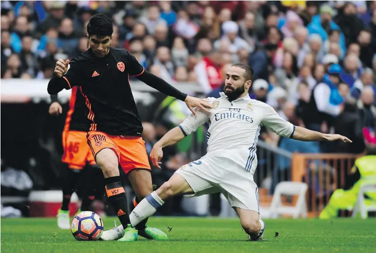  ?? — GETTY IMAGES FILES ?? Real Madrid defender Dani Carvajal, right, says his team needs to win at home to keep Atletico from resorting to its defensive-minded game at the Calderon.