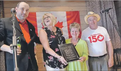  ?? ERIC MCCARTHY/JOURNAL PIONEER ?? Tom Connors Jr., from left, made a presentati­on on behalf of the Connors family, to three people who played a key role in getting the Stompin’ Tom Centre in Skinners Pond open. They are, from second left, Anne Arsenault, general manager of Tignish...