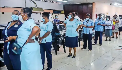  ?? | MOTSHWARI MOFOKENG African News Agency (ANA) ?? NURSES line up to be vaccinated against Covid-19 at the Prince Mshiyeni Memorial Hospital in uMlazi, near Durban, in Frebruary. The country’s vaccinatio­n roll-out is proceeding at a disappoint­ingly slow pace, says the writer.