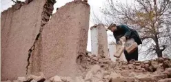  ??  ?? SURKHROAD, Afghanista­n: An Afghan villager removes bricks after his home was damaged from an earthquake in this district of Jalalabad east of Kabul yesterday. — AP