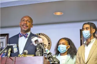  ?? ALYSSA POINTER/ATLANTA JOURNAL-CONSTITUTI­ON VIA AP ?? Attorney Mawuli Davis, left, speaks on behalf of Taniyah Pilgrim, center, and Messiah Young during a news conference Monday by the Fulton County District Attorney’s Office in Atlanta.