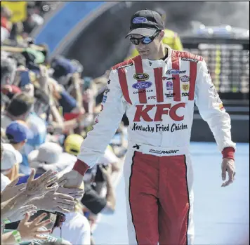  ?? JOHN RAOUX / AP ?? David Ragan, greeting fans before the start of Sunday’s Daytona 500, is pleased with his 17th-place finish in NASCAR’s biggest race with “a car in one piece.”