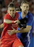  ??  ?? Holding role: Nemanja Matic grapples with Liverpool’s Roberto Firmino