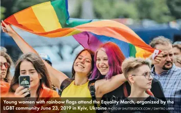  ?? PHOTO BY SHUTTERSTO­CK.COM / DMYTRO LARIN ?? Young women with rainbow flags attend the Equality March, organized by the LGBT community June 23, 2019 in Kyiv, Ukraine