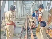  ?? ANI ?? Police personnel inspect the site of explosion on Odha railway bridge in Udaipur on Sunday.