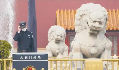  ?? Photo / AP ?? A Chinese police officer stands guard in front of the Tiananmen Gate in Beijing. Members of the Biden Administra­tion are making a first Cabinet-level trip abroad, with China and North Korea the focus.