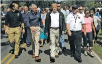  ?? EVAN VUCCI/THE ASSOCIATED PRESS ?? President Donald Trump on Wednesday visits a neighborho­od impacted by Hurricane Florence in Conway, S.C. At left is FEMA Administra­tor Brock Long and South Carolina Gov. Henry McMaster, second from left.