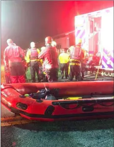  ?? SUBMITTED PHOTO ?? Members of Longwood Fire Co. water rescue team assist in rescuing 11 people from the Brandywine River Sunday night.