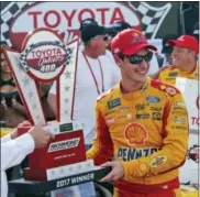  ?? STEVE HELBER — THE ASSOCIATED PRESS ?? Joey Logano celebrates after winning the NASCAR Cup Series auto race with the winners trophy in Victory Lane at Richmond Internatio­nal Raceway in Richmond, Va., Sunday.