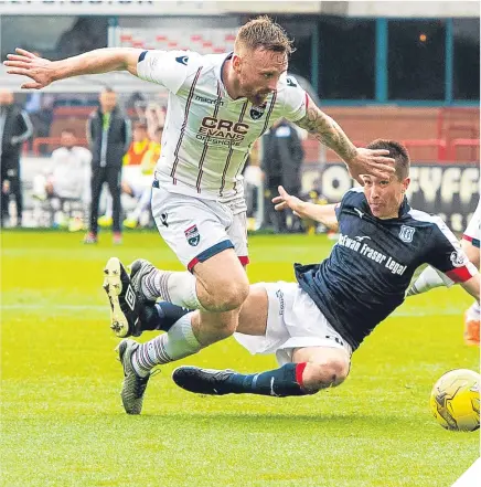  ??  ?? ■ Ross County’s Marcus Fraser (left) brings down Dundee’s Cammy Kerr to concede a penalty.
