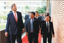  ?? Alex Brandon / AFP / Getty Images ?? John Kerry walks with Ho Chi Minh University of Technology and Education President Do Van Dung before speaking there.