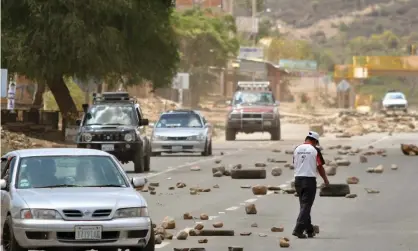  ??  ?? Road Service workers unblock the old road to Santa Cruz in Cochabamba, Bolivia, this week. Photograph: Jorge Abrego/EPA