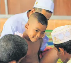  ??  ?? A boy reacts as he is about to undergo ‘sunat’.