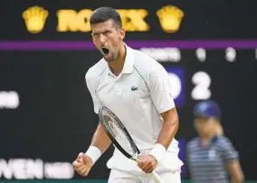  ?? KIRSTY WIGGLESWOR­TH AP ?? Serbia’s Novak Djokovic celebrates winning a point against Tim van Rijthoven.