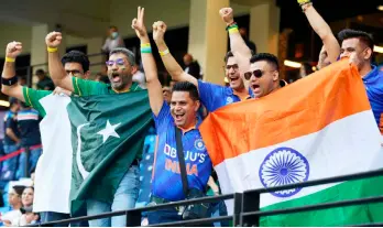  ?? — AFP file photos ?? Fans of Pakistan’s and Indian cricket teams cheer before the start of the ICC men’s Twenty20 World Cup cricket match between India and Pakistan at the Dubai Internatio­nal Cricket Stadium in Dubai.