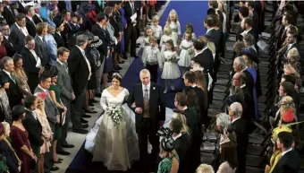  ??  ?? The Duke walks Princess Eugenie down the aisle at her 2018 wedding