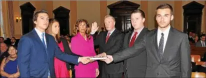  ?? SUBMITTED PHOTO ?? Former county District Attorney Jack Whelan, center, takes the oath of office as he’s sworn in as a new county judge Wednesday. From left are son Ryan, daughter Courtney, wife Peg, Whelan, son Kyle and son Colin.