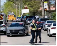  ?? (AP/Knoxville News Sentinel/Brianna Paciorka) ?? Police work in the area of Austin-East Magnet High School in Knoxville, Tenn., after a shooting Monday. Officers responding to a report of a possible gunman at the school encountere­d an armed student who then opened fire, authoritie­s said. The student was fatally shot, and an officer was wounded and taken into surgery.