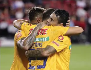  ?? RICHARD LAUTENS TORONTO STAR ?? Members of the UANL Tigres, champions of Mexican soccer, celebrate a first-half goal at BMO Field. They won the Campeones Cup over TFC by a 3-1 score.