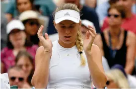  ?? Bild: TOBY MELVILLE ?? UTSLAGEN. Danska Caroline Wozniacki fick bara spela två matcher i årets Wimbledon.