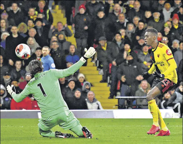  ?? AFP ?? Watford's Ismaila Sarr (right) scores his and team's second goal past Liverpool goalkeeper Alisson Becker in the Premier League clash at Vicarage Road on Saturday.