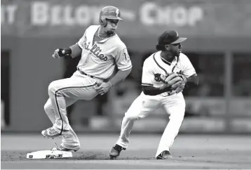  ?? Associated Press ?? ■ Philadelph­ia Phillies' Cesar Hernandez (16) is forced out at second base by Atlanta Braves second baseman Ozhaino Albies (1) on a Carlos Santana ground ball in the first inning of an opening day baseball game Thursday in Atlanta.