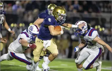  ?? (Special to the NWA Democrat-Gazette/David Beach) ?? Eli Wisdom of Shiloh Christian (middle) stiff-arms Arkadelphi­a’s Alex Turley as he runs on a quarterbac­k keeper during the Saints 57-54 victory over the Badgers in the Class 4A state playoff semifinals at Champions Stadium in Springdale.