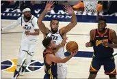  ?? RICK BOWMER — THE ASSOCIATED PRESS, FILE ?? Warriors guard Stephen Curry, foreground, goes to the basket as Jazz center Rudy Gobert, center rear, defends during the first half on Jan. 23in Salt Lake City.