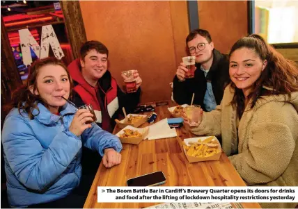  ??  ?? > The Boom Battle Bar in Cardiff’s Brewery Quarter opens its doors for drinks and food after the lifting of lockdown hospitalit­y restrictio­ns yesterday