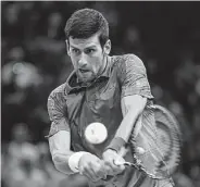  ?? Anne-Christine Poujoulat / AFP/Getty Images ?? Novak Djokovic smoothly moves into the third round of the Paris Masters by pounding out a victory over Joao Sousa.