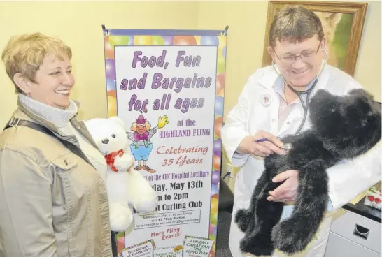  ?? FILE ?? Vicki Daley looks on as Dr. Brian Ferguson checks the heart rate of a teddy bear in preparatio­n for a previous edition of the Cumberland Health Care Auxiliary's Highland Fling. The auxiliary has announced it’s joining with the Cumberland Health Care Foundation, ending 115 years of service.