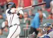  ?? / AP-John Bazemore ?? The Braves’ Kurt Suzuki hits a 2 RBI single against the Los Angeles Dodgers during the fourth inning in Game 4 of baseball’s National League Division Series in Atlanta on Oct. 8.