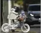  ?? MARK SCHIEFELBE­IN THE ASSOCIATED PRESS ?? A vehicle drives past a memorial earlier this month for 5-year-old Allie Hart, who was struck and killed in 2021 by a driver while riding her bicycle in a crosswalk in Washington.
