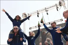  ??  ?? Consummate showman…
Virgin Galactic founder Sir Richard Branson (left), with Sirisha Bandla on his shoulders, cheers with crew members after flying into space aboard a Virgin Galactic vessel, a voyage he described as the “experience of a lifetime”.