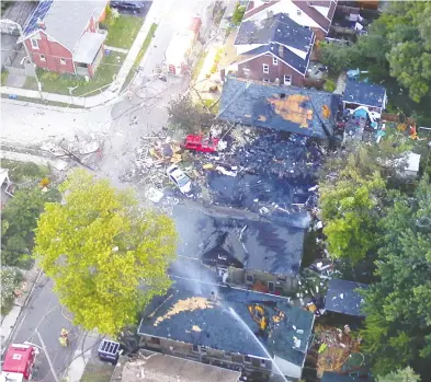  ?? THE CANADIAN PRESS / LONDON POLICE SERVICE ?? An aerial view shows the scene Thursday where a motorist slammed into a house in London, Ont., causing a gas line to explode. Hundreds of people were displaced from their homes late Wednesday as firefighte­rs battled several blazes that following the initial blast, which destroyed the house. Police say a Kitchener, Ont., woman has been charged
with impaired driving relating to the crash, which triggered several explosions and sent seven to hospital.