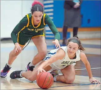  ?? SARAH GORDON/THE DAY ?? New London’s Nyarah Dudley (1) and Bacon Academy’s Emily Ferrigno (11) dive for a ball during Wednesday night’s girls’ basketball game in Colchester. Bacon won 54-51.