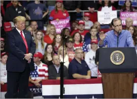  ?? MICHAEL CONROY — THE ASSOCIATED PRESS ?? President Donald Trump listens as Senate candidate Mike Braun speaks at a campaign rally at the Allen County War Memorial Coliseum in Fort Wayne, Ind., on Monday.