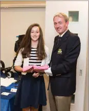  ??  ?? Lauren Ryan, a winner in the President’s Prize competitio­n at Blainroe Golf Club, receives herprize from Club President Terence Ryan