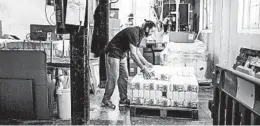  ?? ALEX ATACK/THE NEW YORK TIMES ?? Bags of flour are loaded onto a pallet May 15 at Wessex Mill in Wantage, England.