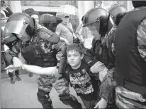  ?? Associated Press ?? A young demonstrat­or is apprehende­d by riot police Monday during a demonstrat­ion in downtown Moscow. Russian opposition leader Alexei Navalny, aiming to repeat the nationwide protests that rattled the Kremlin three months ago, has called for a...