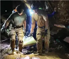  ??  ?? One of the 12 boys is carried out on a stretcher during the rescue operation in the Tham Luang cave. Photo: Royal Thai Navy/AFP