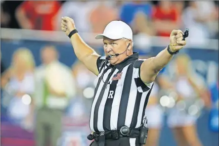  ?? [AP PHOTO] ?? Referee Mike Defee was the hero of the Oklahoma-Texas game on Saturday in the Cotton Bowl. After a pregame rumble between players, Defee defused more fireworks by telling team captains that the game would be played with sportsmans­hip -- or else.