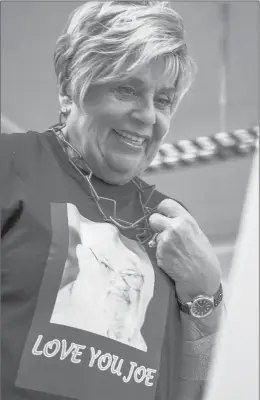  ?? JOHNATHON HENNINGER/SPECIAL TO THE COURANT ?? Patricia Heller, wife of Richard Heller and sister-in-law to Joe Heller, smiles while looking at photos of her family during a memorial service on Thursday in Essex.