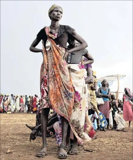  ?? PICTURE: REUTERS/AFRICAN NEWS AGENCY (ANA) ?? QUEUEING FOR BASIC RIGHTS: Women and children displaced by recent fighting between rebel soldiers and government troops wait to collect food rations in South Sudan’s Mingkaman refugee camp in this file picture.