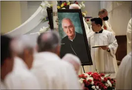  ?? ?? A portrait of Patrick J. McGrath is displayed during his funeral Mass. “Bishop PJ” came to the Bay Area in the 1970s.