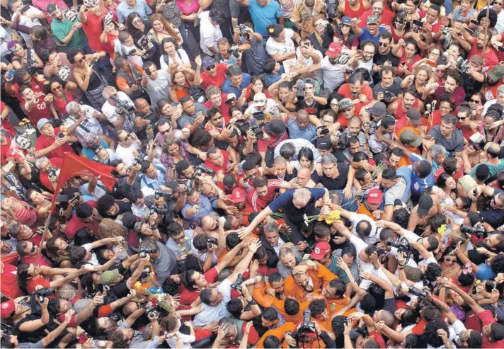  ??  ?? ► El ex presidente brasileño, Luiz Inácio Lula da Silva es llevado por partidario­s frente al sindicato metalúrgic­o en Sao Bernardo do Campo, Brasil.